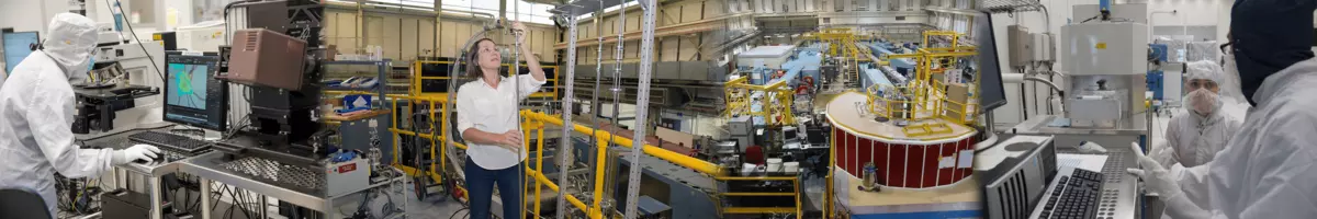 Numerous workers using machinery in a large workspace.